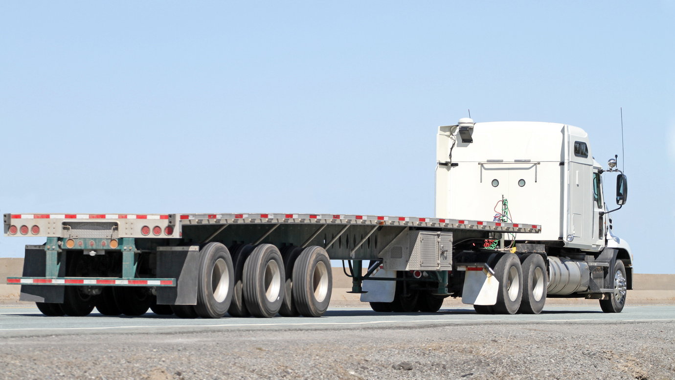 Semi Tractor Trailer Flatbed Truck With No Load On Highway